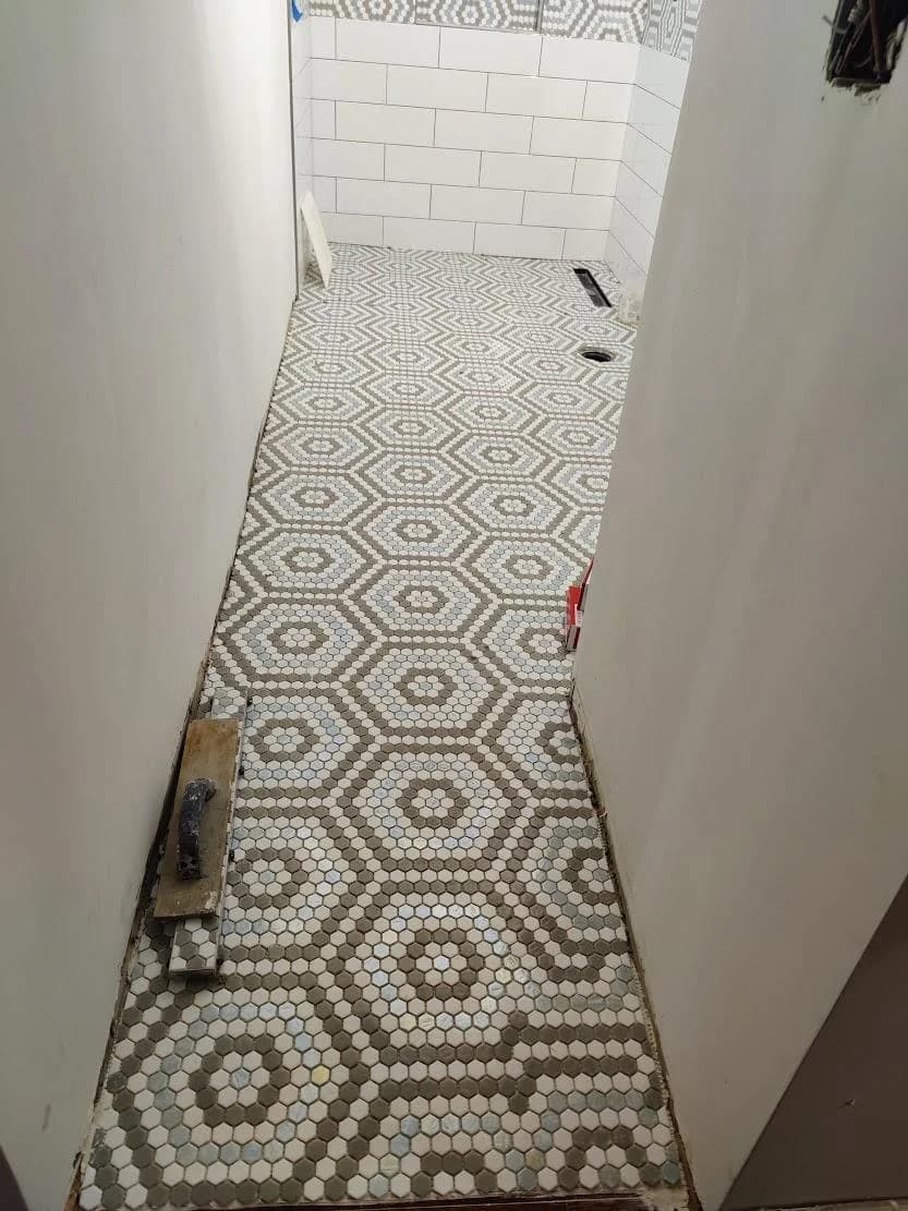Pattern tile floor layout running through a narrow space